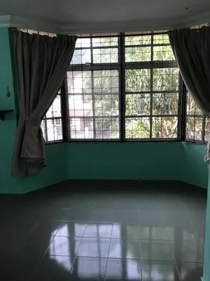 a room with green walls and windows and a tiled floor at Suria Permai Homestay in Taiping