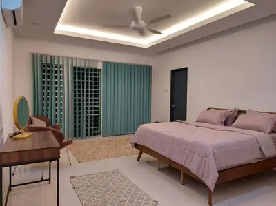 a bedroom with a bed and a ceiling fan at Yong Guesthouse in Kuala Kangsar