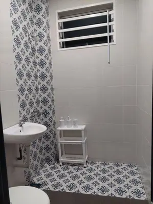 a bathroom with a sink and a toilet at Yong Guesthouse in Kuala Kangsar