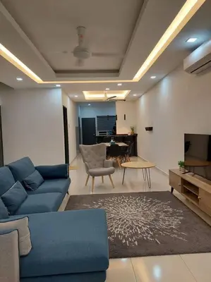 a living room with a blue couch and a table at Yong Guesthouse in Kuala Kangsar