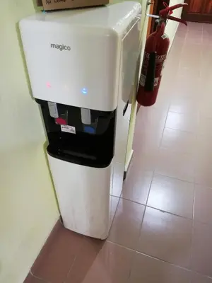 a white and black refrigerator sitting in a kitchen at Evonne Budget Hotel in Tanah Rata