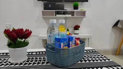 a basket filled with drinks and snacks on a table at Embon Homestay in Padang Serai