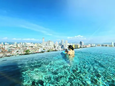 a woman sitting on the edge at Beacon Executive Suites - George Town in George Town