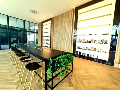 a long black table and chairs in a room at Beacon Executive Suites - George Town in George Town