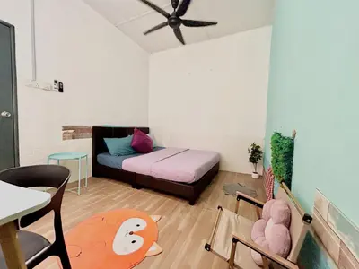 a room with a bed and a table and chairs at Entire Cozy Home 16 • 3 bedroom @ Alma Bukit Mertajam in Bukit Mertajam