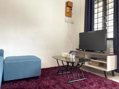 a living room with a tv and a coffee table at Entire Cozy Home 16 • 3 bedroom @ Alma Bukit Mertajam in Bukit Mertajam