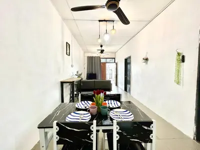 a dining room with a table and a ceiling fan at Entire 33 Cozy House • 3 Bedroom @ Alma Bukit Mertajam in Bukit Mertajam