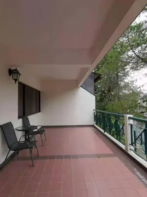 a room with a table and chairs on a balcony at Cozy Home Copthorne Equatorial Hill Resort in Brinchang