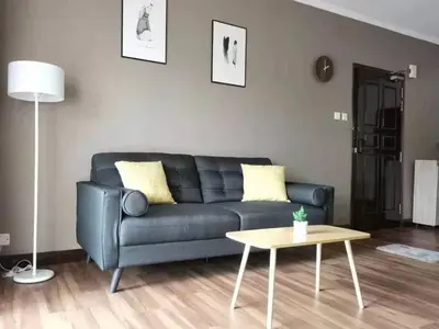 a living room with a black couch and a table at Cozy Home Copthorne Equatorial Hill Resort in Brinchang