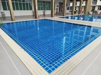 a swimming pool with blue tiles in a building at Adelea Homestay MERU in Ipoh