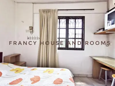 a bedroom with a bed and a window at Chill and Traditional House in Bercham Ipoh in Ipoh