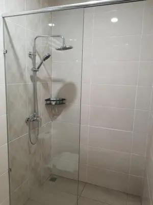 a shower with a glass door in a bathroom at T SQUARE HOTEL (IPOH) in Ipoh