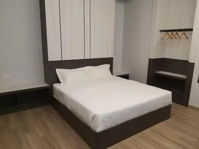 a bedroom with a bed with white sheets and white pillows at T SQUARE HOTEL (IPOH) in Ipoh