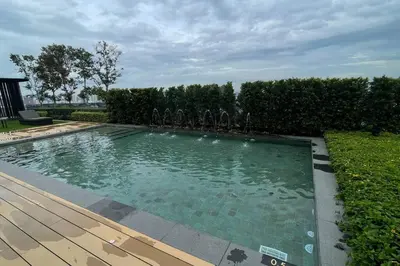 a swimming pool in a yard with a wooden deck at Beacon Suites with Infinity Pool at Georgetown by WL in George Town