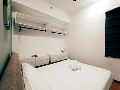 a white room with a bed and a sink at Beacon Suites with Infinity Pool at Georgetown by WL in George Town