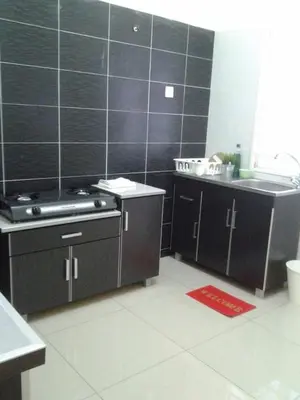 a kitchen with a stove and a sink at KS Lavender Kuala Kangsar in Kuala Kangsar
