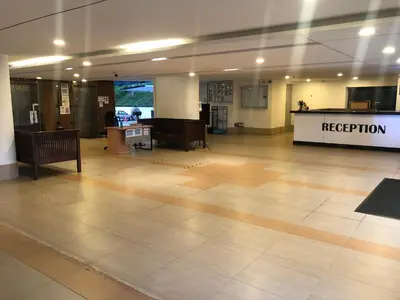 an empty lobby with a reception desk in a building at Beach Resort Home Stay SRI SAYANG APARTMENT BATU FERRINGHI 2BEDROOM in Batu Ferringhi