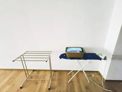 a chair and a table in front of a wall at The Venus Sri Manjung Block B High Floor in Seri Manjung
