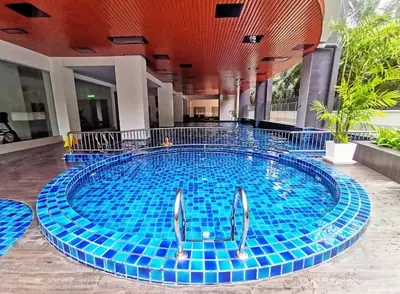 a large swimming pool with blue tiles in a building at The Venus Sri Manjung Block B High Floor in Seri Manjung