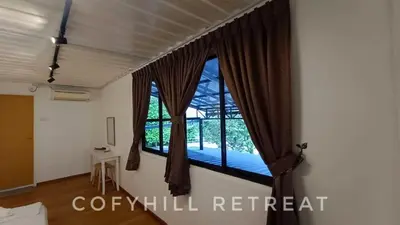 a room with a window with a bed in it at CofyHill Retreat in Kampong Changkat Tualang