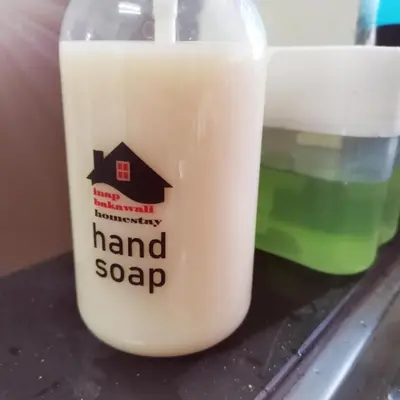 a bottle of almond milk with a house on it at Homestay Inap Bakawali Seri Iskandar in Seri Iskandar