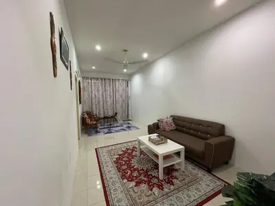 a living room with a couch and a table at Rose Homestay in Sitiawan
