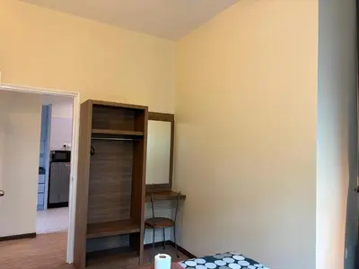 a room with a closet and a room with a table at Gerard's Place Nature Haven Apartment in Tanah Rata