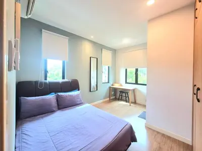 a bedroom with a bed and a room with a table at FERRINGHI RESORT 5-BEDROOM with POOL, BBQ SET, WiFi, Netflix & WALK to BEACH in Batu Ferringhi
