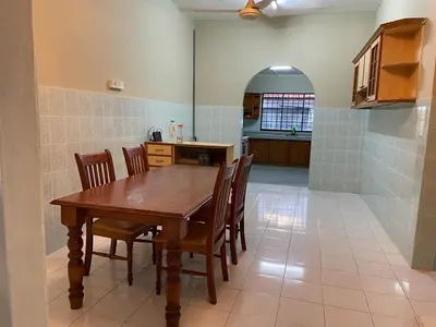 a kitchen with a wooden table and chairs at To' Teh Homestay in Ipoh