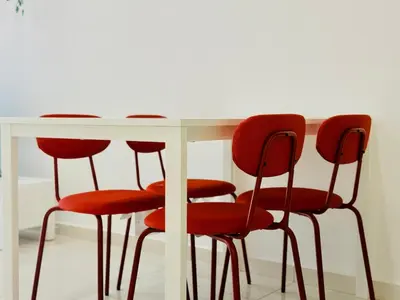 a white table with four red chairs around it at 2BR Luxury Rooftop Swimming Pool Beacon Georgetown10pax \u65e0\u654c\u7f8e\u666f\u4e24\u623f\u6c11\u5bbf in George Town