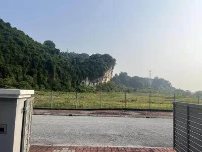 an empty road with a fence in front of a field at LOW SEASON PROMOTION! Mountainview Corner Lot 10 pax in Ipoh