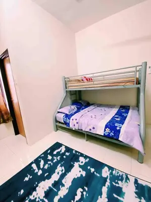 a small room with a bunk bed and a rug at Spacious cozy Lakeville homestay 4 bedrooms all with AirCond in Seri Iskandar