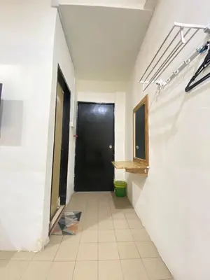 a hallway with a black door in a room at Hotel station 24 in Sungai Besar