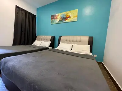 two beds in a room with blue walls at Golden Hill Home by Dreamscape in Cameron Highlands
