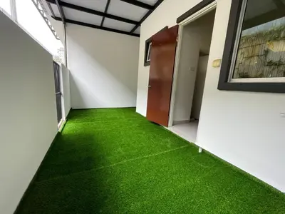 a hallway with green grass in a building at Golden Hill Home by Dreamscape in Cameron Highlands