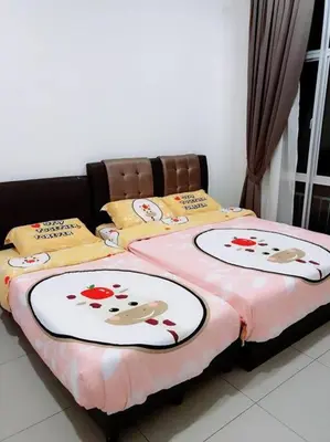 a bedroom with two beds with flowers on them at W3WarmStay@GoldenHills/3RPenthouse/WiFi/PasarMalam/2carpark in Brinchang