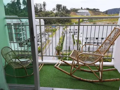 two chairs on a balcony with a view of a street at W6WarmStay@GoldenHills/3RPenthouse/WiFi/PasarMalamView/2carpark in Brinchang