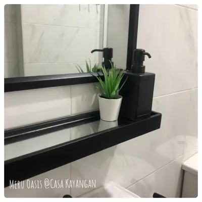 a bathroom with a mirror and a plant on a shelf at Meru Oasis at Casa Kayangan Ipoh in Ipoh