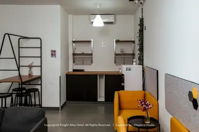 a kitchen with a counter and a table and a refrigerator at Knight Alley Hotel in Taiping