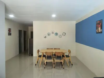 a dining room with a table and chairs at Manhattan Condo Ipoh with Water Park and Pool View in Ipoh
