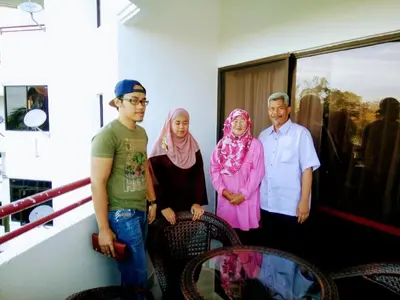 a group of three people standing in a room at AGODA C VIEW @ Sri Sayang Beach Resort in Batu Ferringhi
