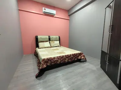a bedroom with a bed and a pink wall at Alish Homestay Gua Musang with Free WiFi, Netflix in Gua Musang