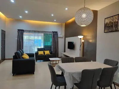 a living room with a table and chairs and a couch at W13 atGoldenHills NightMarket WiFi 4R in Brinchang