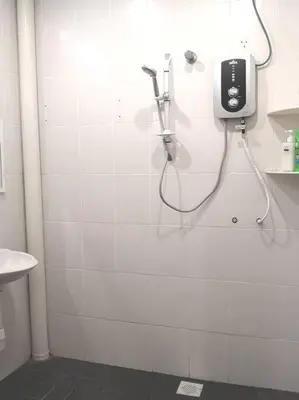 a bathroom with a shower with a phone on the wall at W13 atGoldenHills NightMarket WiFi 4R in Brinchang