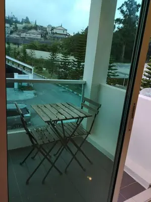 a table and chairs on a balcony with a view at W36 WarmStay atGoldenHills NightMarket 4R Wifi BBQ in Brinchang