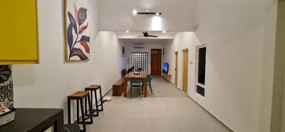 a hallway with chairs and a table in a room at Guesthouse @ Ipoh garden II in Ipoh