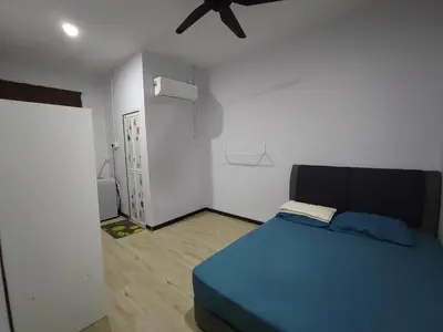 a bedroom with a blue bed and a ceiling fan at Homestay De' Humaira - USM Nibong Tebal in Nibung Tebal