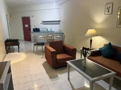 a living room with a couch and a table at Paradise by the Sea in Penang by Veron at Rainbow Paradise in Tanjung Bungah