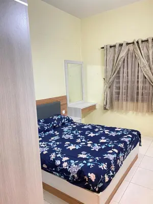 a bedroom with a bed with a blue floral blanket at Azzalea Homes 5 @ Golden Hills Cameron Highlands in Brinchang