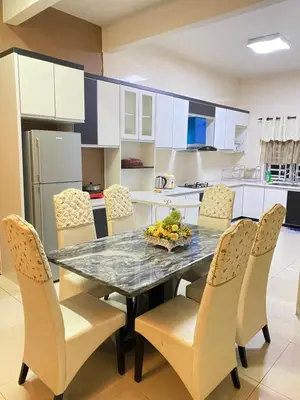 a kitchen with a dining room table and chairs at Azzalea Homes 5 @ Golden Hills Cameron Highlands in Brinchang
